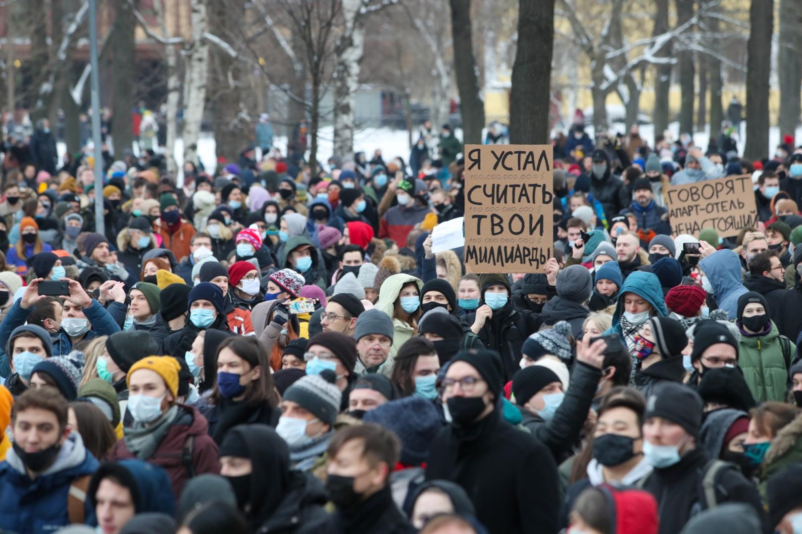 ST PETERSBURG, RUSSIA - JANUARY 31, 2021: Demonstrators attend an unauthorised protest in support of the detained opposition activist Alexei Navalny. The message on the sign in the centre reads: "I am tired of counting your billions." Navalny, who had been handed a suspended sentence in the Yves Rocher case in 2014, was detained at Sheremetyevo Airport near Moscow on 17 January 2021 for violating probation conditions. A court ruled that Navalny be put into custody until 15 February 2021. Alexander Demianchuk/TASS Photo via Newscom Newscom/PIXSELL