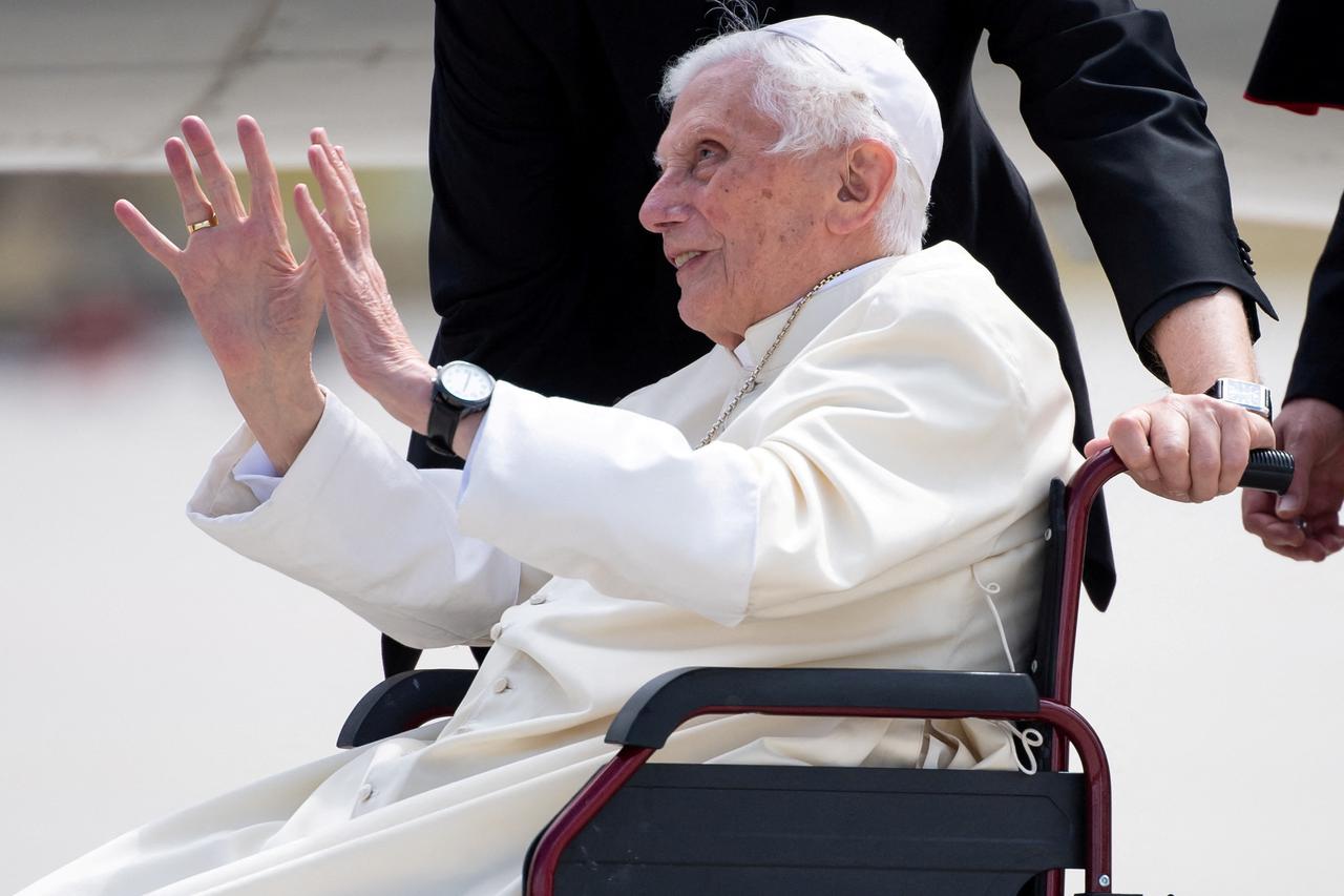 FILE PHOTO: Pope Emeritus Benedict XVI gestures at the Munich Airport before his departure to Rome