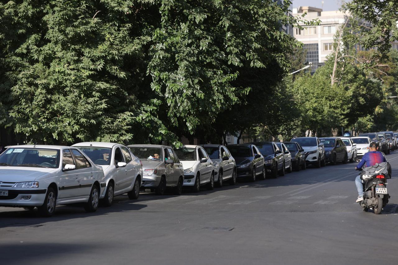 Cars are lined up near a gas station following the Israeli strikes on Iran, in Tehran