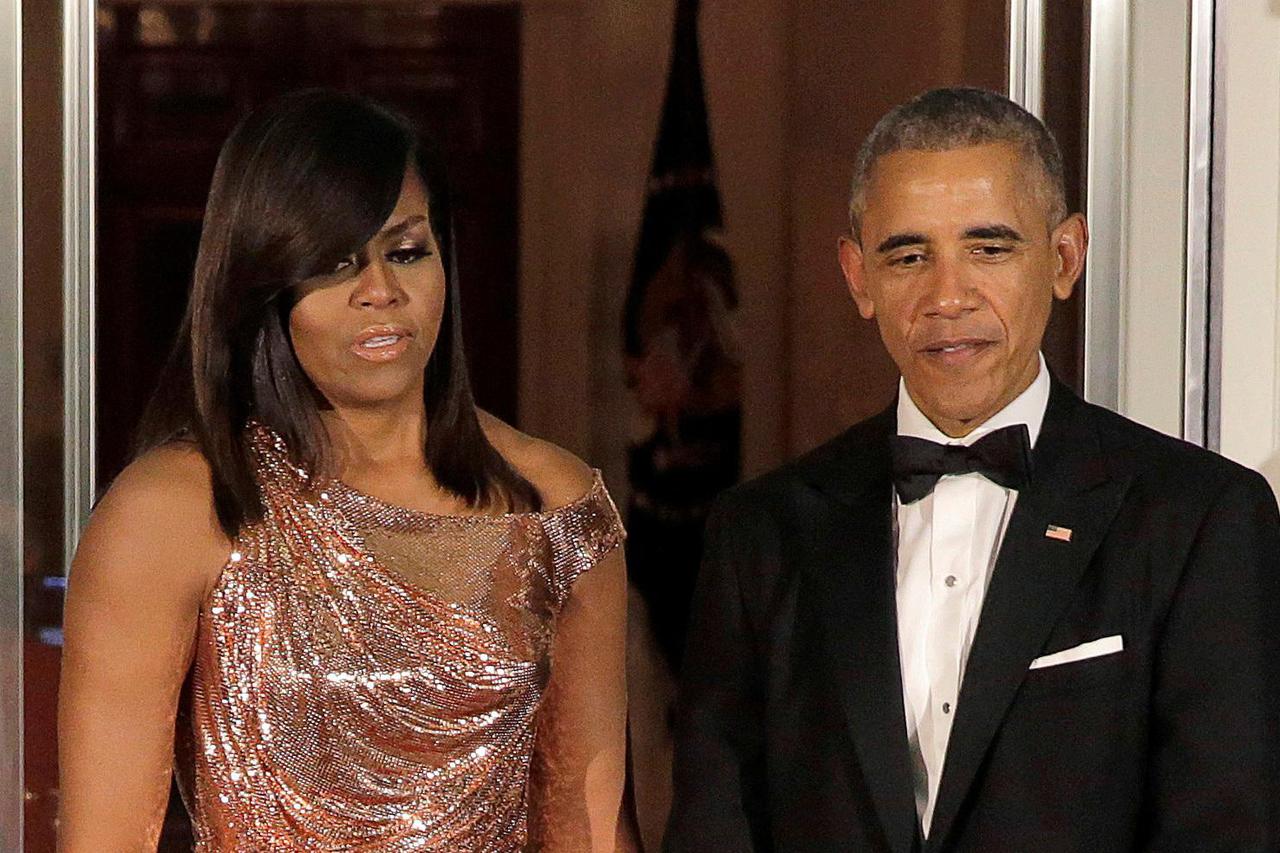 FILE PHOTO: U.S. President Barack Obama and U.S. first lady Michelle Obama stand together before the arrival of Italian Prime Minister Matteo Renzi and his wife Agnese Landini at the White House in Washington.