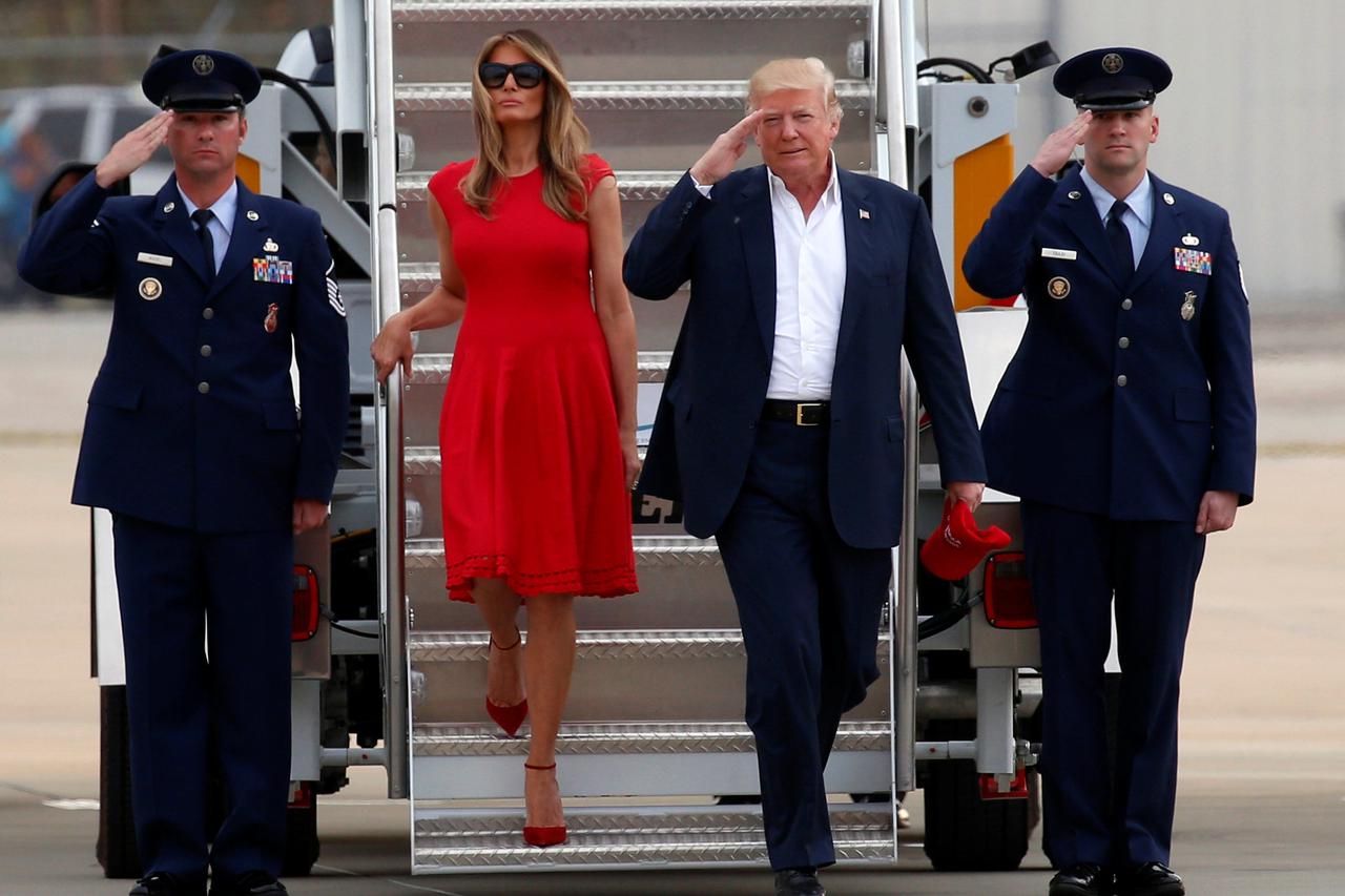 U.S. President Donald Trump and first lady Melania Trump step from Air Force One to attend a 