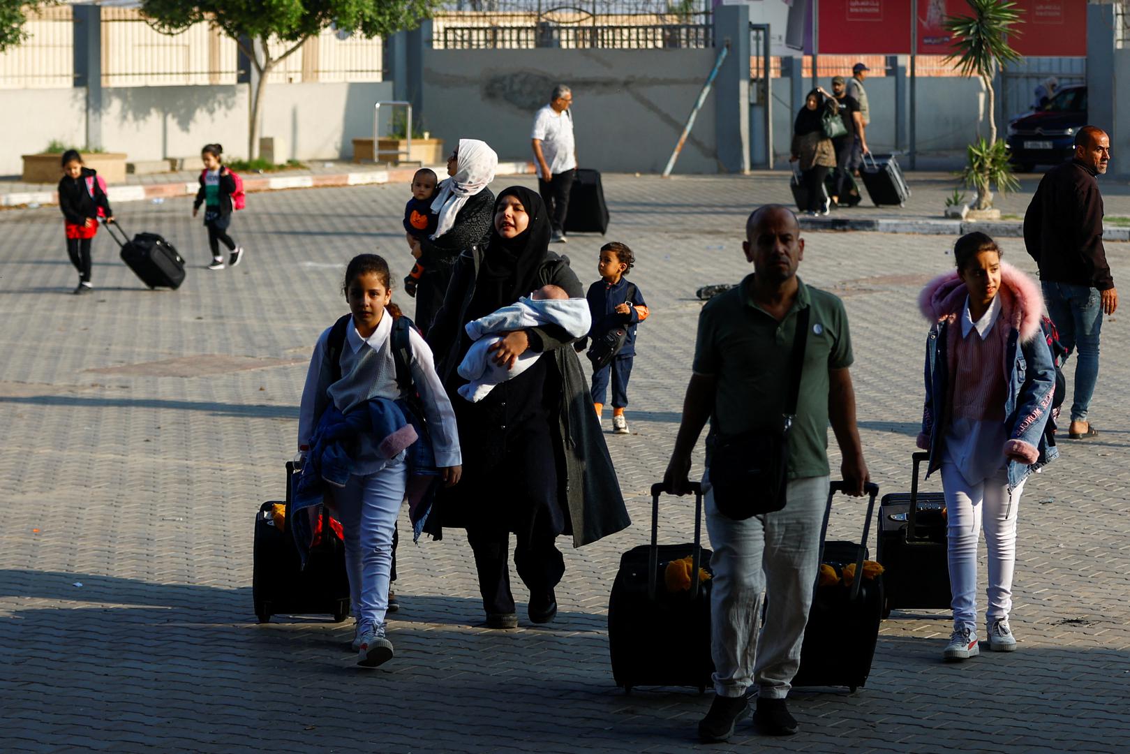 Palestinians with dual citizenship walk as they wait for permission to leave Gaza, amid the ongoing conflict between Israel and Palestinian Islamist group Hamas, at the Rafah border crossing with Egypt, in Rafah in the southern Gaza Strip, November 2, 2023. REUTERS/Ibraheem Abu Mustafa Photo: IBRAHEEM ABU MUSTAFA/REUTERS