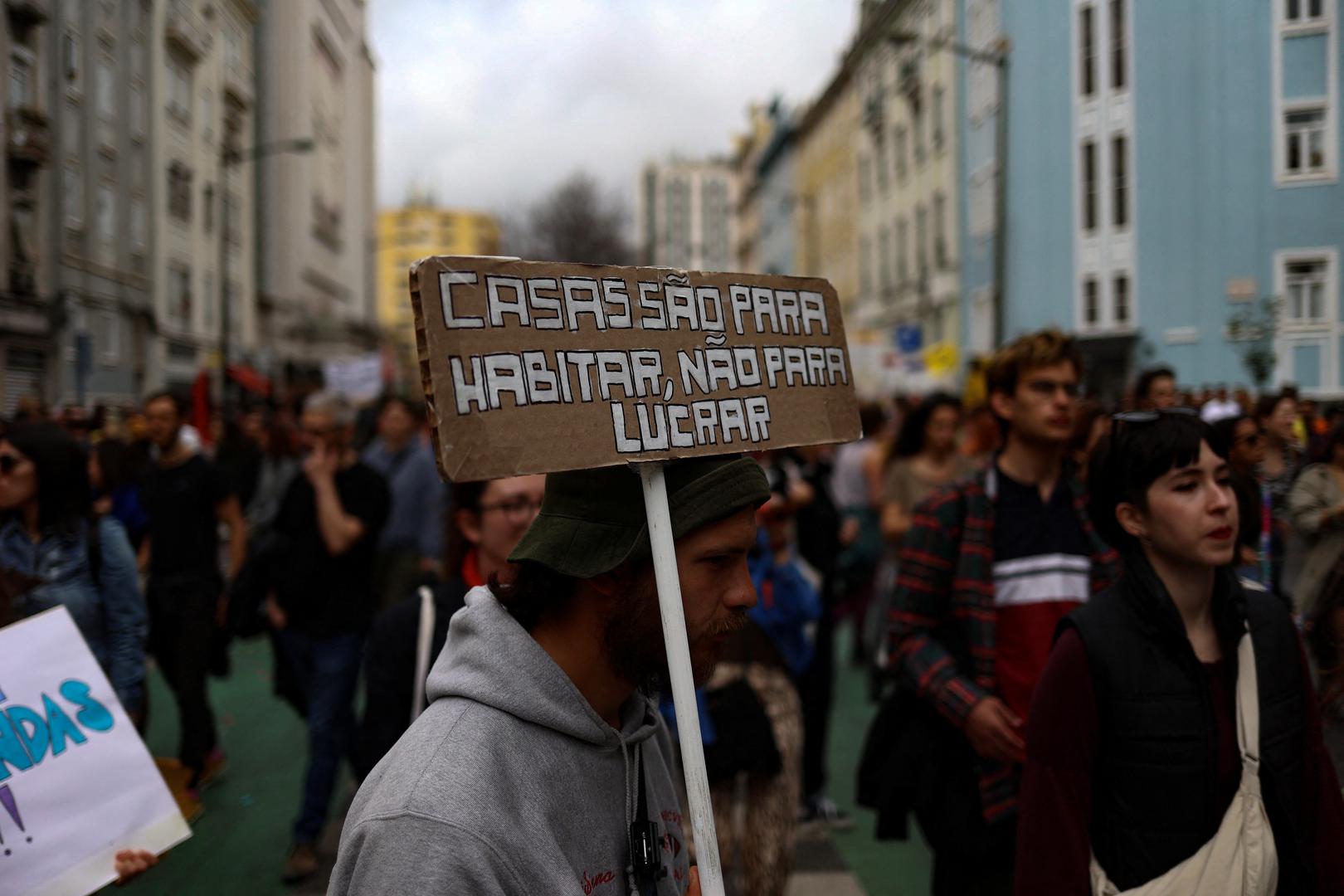 A man carries a placard that reads: "Houses are for living, not for profits" as people demonstrate for the right to affordable housing in Lisbon, Portugal, April 1, 2023. REUTERS/Pedro Nunes Photo: PEDRO NUNES/REUTERS