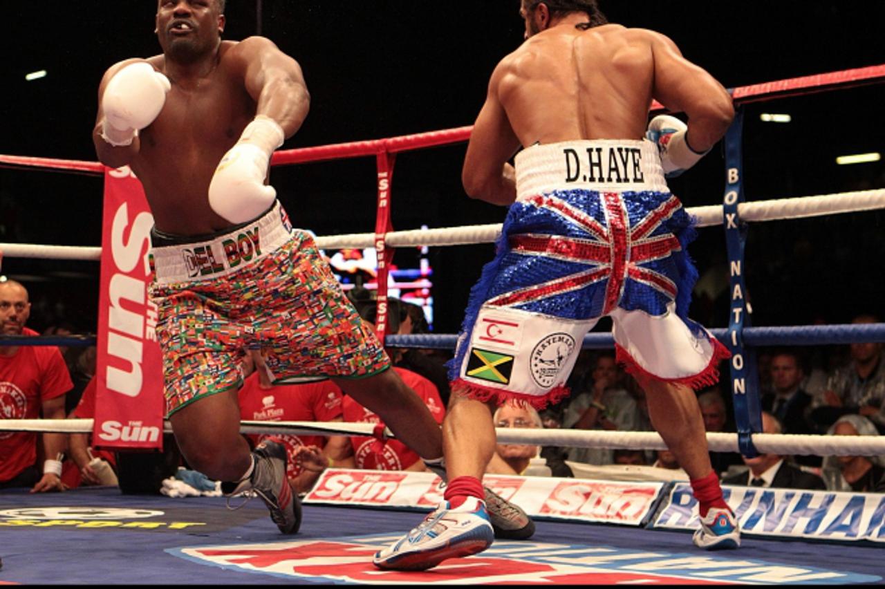 'David Haye knocks down Dereck Chisora (left) in their WBA and WBO International Heavyweight Championship bout at Upton Park, London. Photo: Press Association/Pixsell'