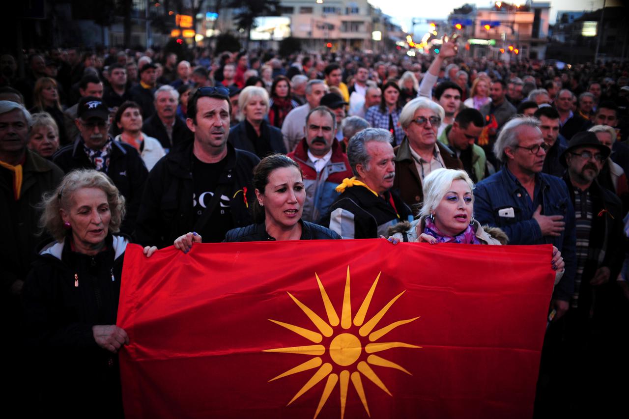 Protesters shout slogans while holding a Macedonian flag during demonstrations against an agreement that would ensure the wider use of the Albanian language in the ethnically divided state, in Skopje, Macedonia, February 28, 2017. REUTERS/Stringer
