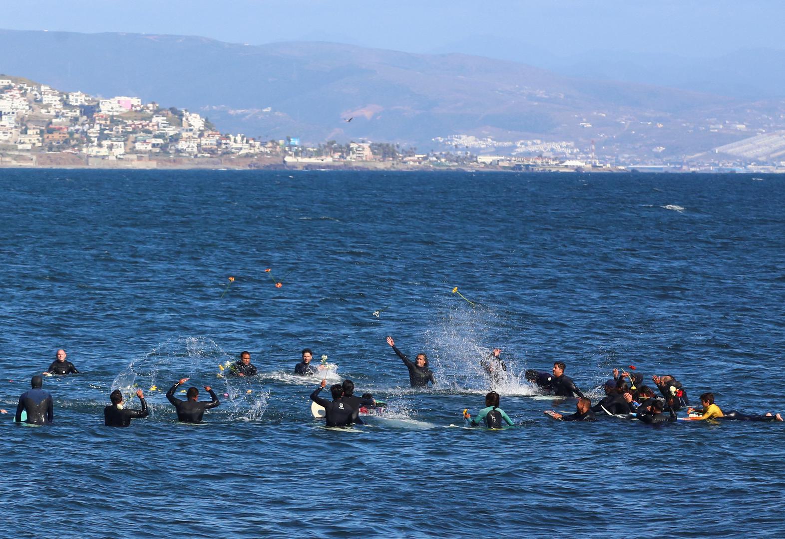 Local surfers throw flowers during a demonstration calling for authorities to solve the disappearances of U.S. and Australian surfers in Ensenada after Mexican authorities said the parents of the missing tourists arrived in Mexico to try to identify the dead bodies believed to be their children, in Ensenada, Mexico May 5, 2024. REUTERS/Jorge Duenes Photo: JORGE DUENES/REUTERS