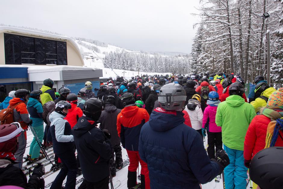 People queue to go skiing and snowboarding in the moutain resort of Zieleniec