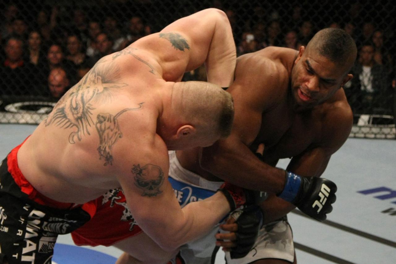 'LAS VEGAS, NV - DECEMBER 30:  Alistair Overeem (right) punches Brock Lesnar (left) during the UFC 141 event at the MGM Grand Garden Arena on December 30, 2011 in Las Vegas, Nevada.  (Photo by Donald 