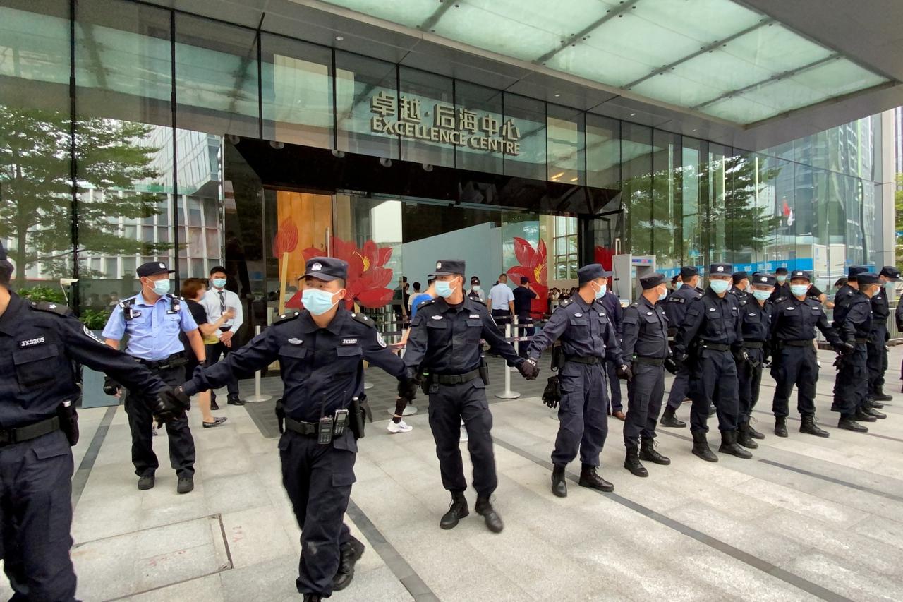 FILE PHOTO: People protest to demand repayment of loans and financial products at the Evergrande's headquarters, in Shenzhen