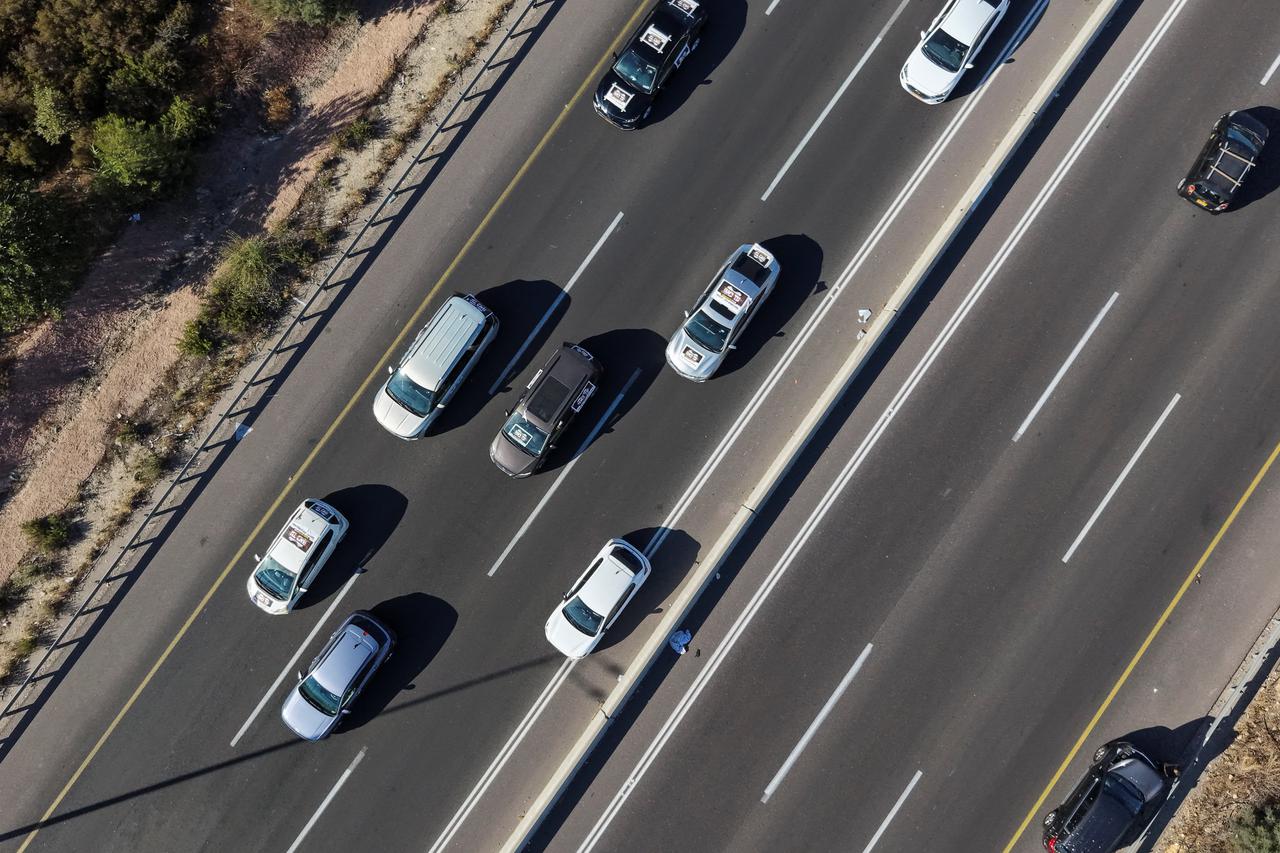 A convoy of cars of ultra-Orthodox Jewish protesters drives on a highway outside of Jerusalem