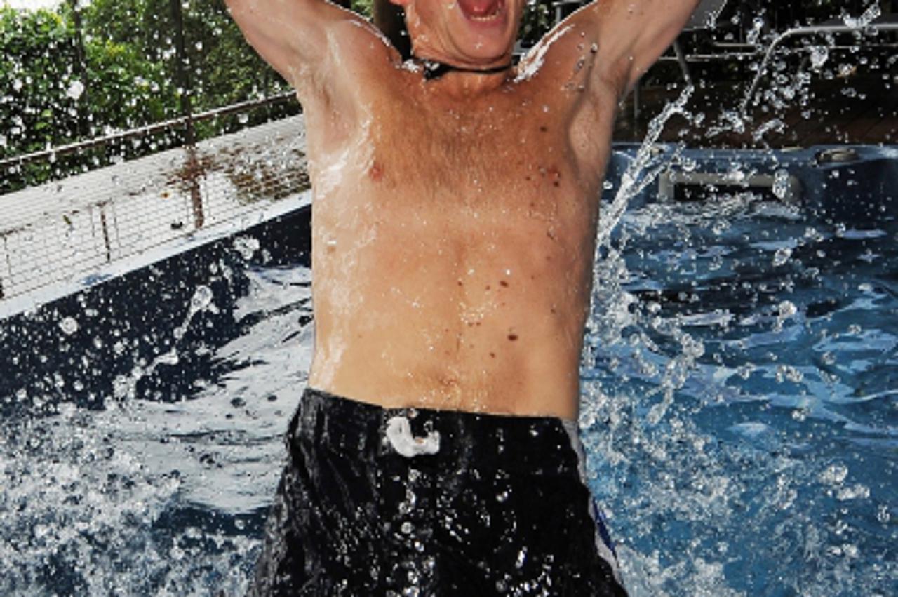 \'(FILES)  British fundraiser Ben Southall tries out the jacuzzi spa of his \'Blue Pearl\' accommodation after winning the \'Best Job In The World\' competition on Hamilton Island in the Whitsunday Is