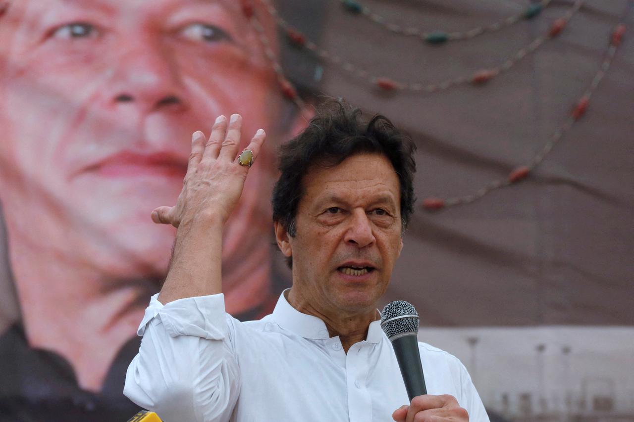 FILE PHOTO: PTI chairman Imran Khan  gestures while addressing his supporters during a campaign meeting ahead of general elections in Karachi