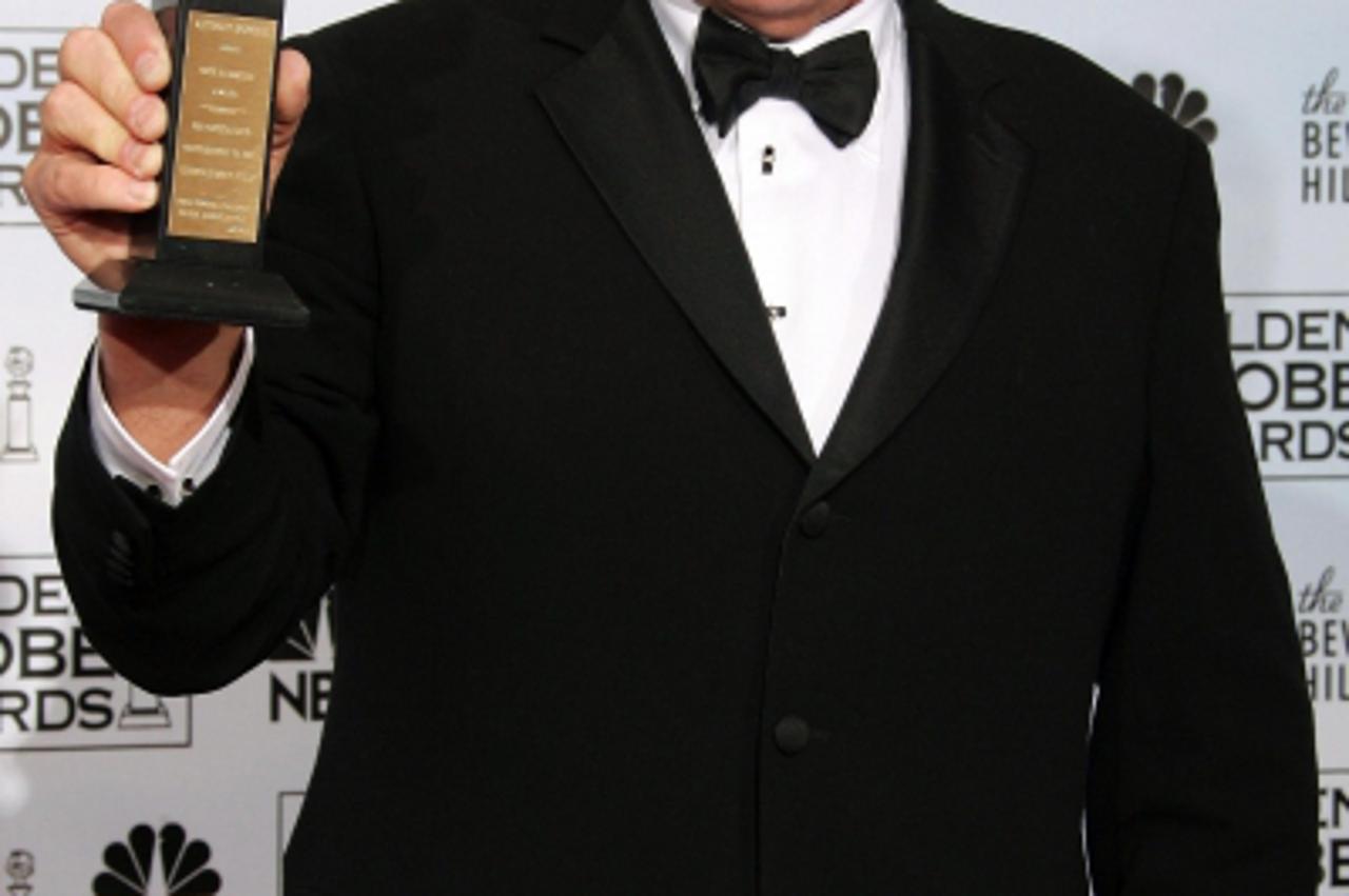 'Actor Anthony Hopkins shows his Cecil B. DeMille Award for outstanding contribution to the world of entertainment at the 63rd Annual Golden Globe Awards in Beverly Hills, California January 16, 2006.