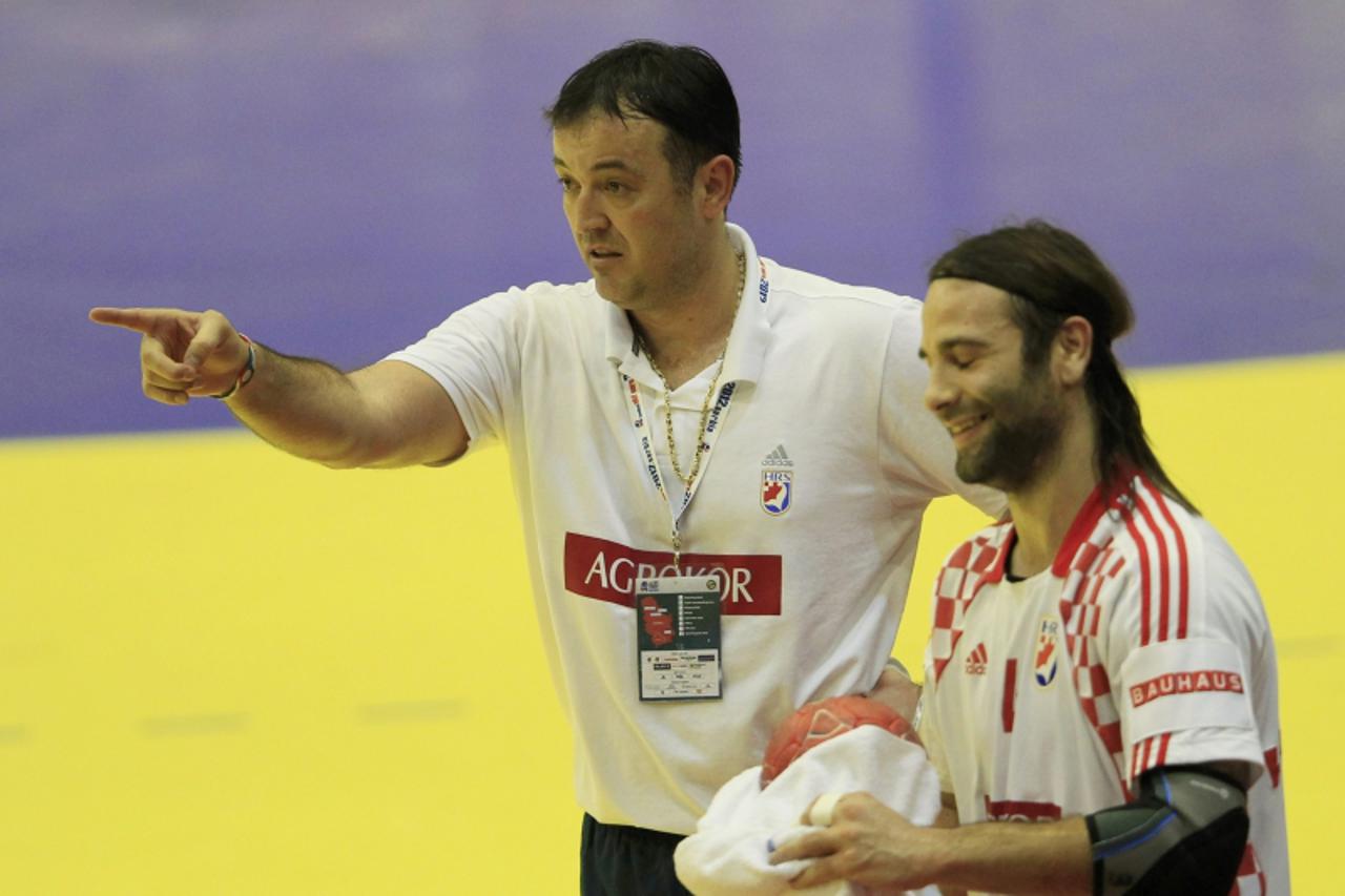 'Croatia\'s head coach Slavko Goluza (R) and player Ivano Balic (L) react during game against Spain at their Men\'s European Handball Championship main round match in Novi Sad January 22, 2012.       