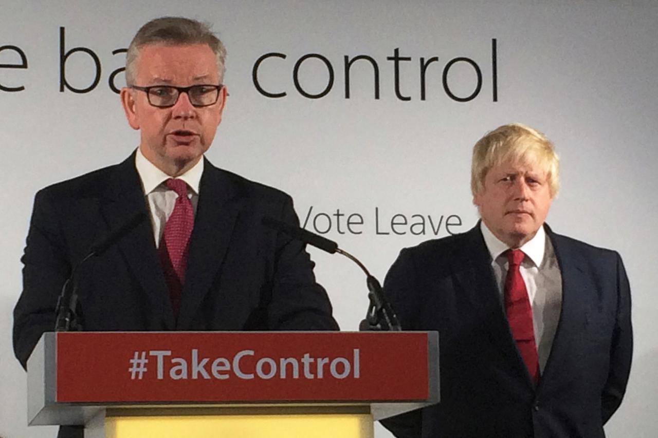 FILE PHOTO: Britain's Justice Secretary Michael Gove speaks as Vote Leave campaign leader Boris Johnson listens at the group's headquarters in London