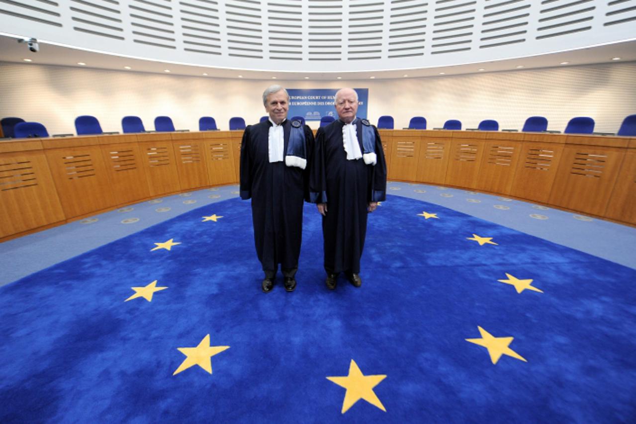 'President of the European Court of Human Rights French Jean-Paul Costa (R) poses with his successor, British Nicolas Dusan Bratza, on October 19, 2011, in Strasbourg, eastern France.  AFP PHOTO / PAT