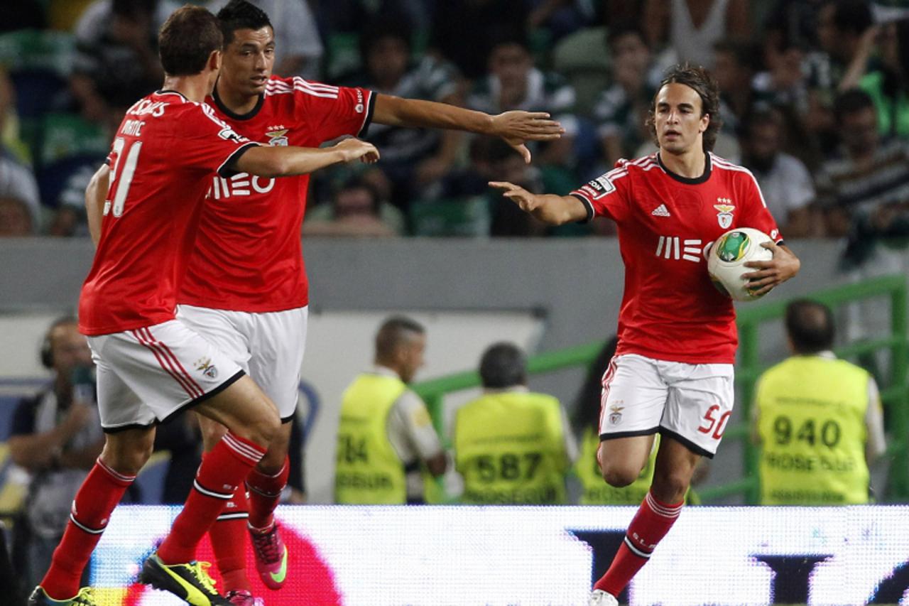 'Benfica's Lazar Markovic (R) celebrates his goal against Benfica with teammates Oscar Cardozo (2nd L) and Nemanja Matic during their Portuguese Premier League soccer match at the Alvalade stadium in