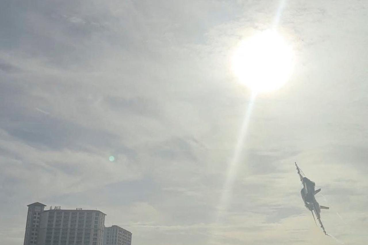 A Navy Blue Angels jet flies low over the crowd on Pensacola Beach