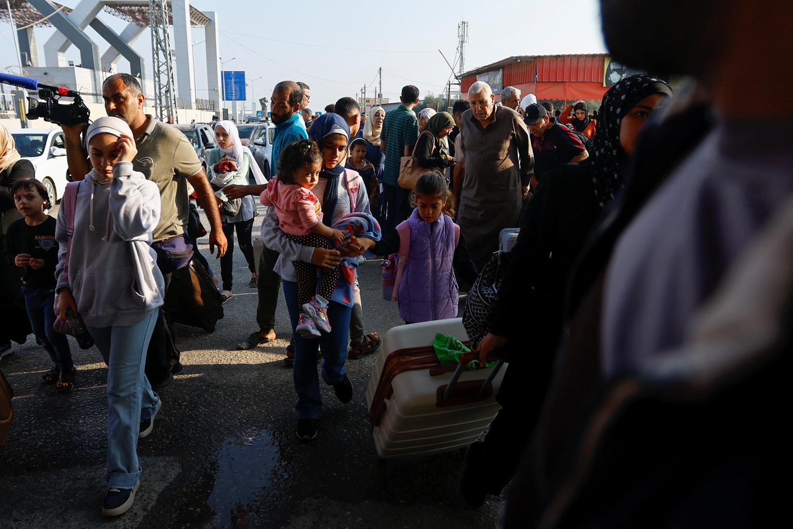 Palestinians with dual citizenship walk as they wait for permission to leave Gaza, amid the ongoing conflict between Israel and Palestinian Islamist group Hamas, at the Rafah border crossing with Egypt, in Rafah in the southern Gaza Strip, November 2, 2023. REUTERS/Ibraheem Abu Mustafa Photo: IBRAHEEM ABU MUSTAFA/REUTERS