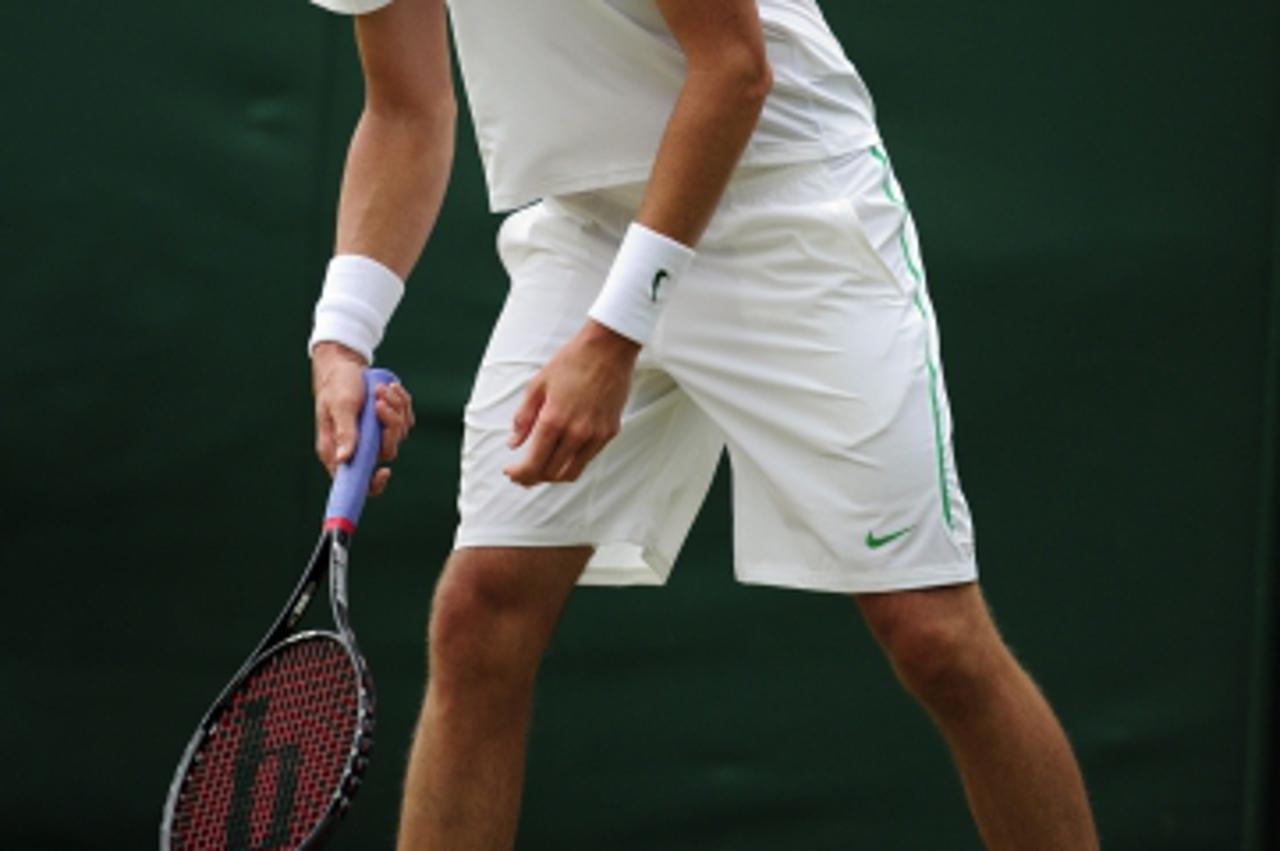 \'USA\'s John Isner in action during his match against Spain\'s Nicolas Almagro on day four of the 2011 Wimbledon Championships at the All England Lawn Tennis and Croquet Club, Wimbledon. Photo: Press