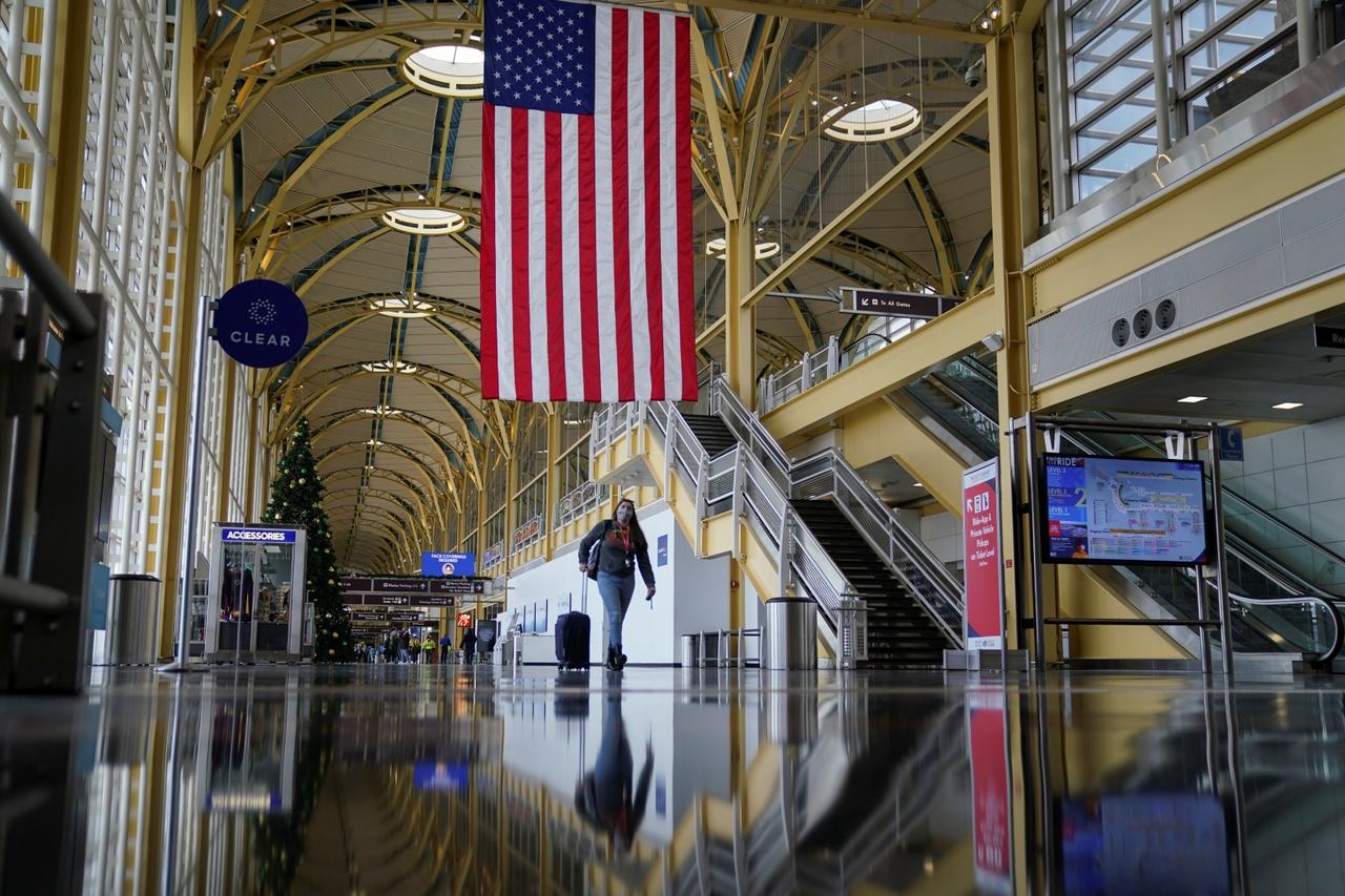 A Christmas week traveler makes her way through Ronald Reagan Washington National Airport in Arlington, Virginia