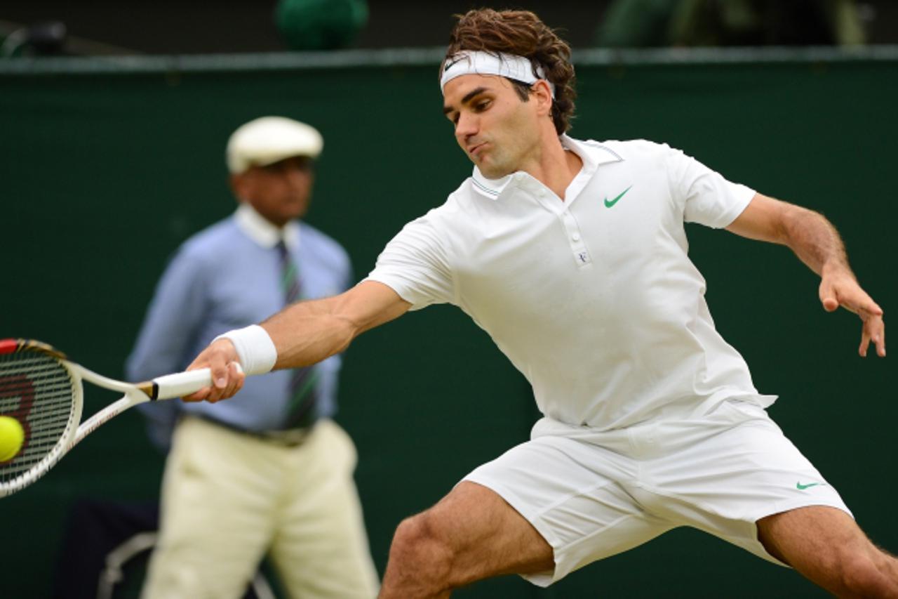 'Switzerland\'s Roger Federer plays a forehand shot during his men\'s singles semi-final victory over Serbia\'s Novak Djokovic on day 11 of the 2012 Wimbledon Championships tennis tournament at the Al