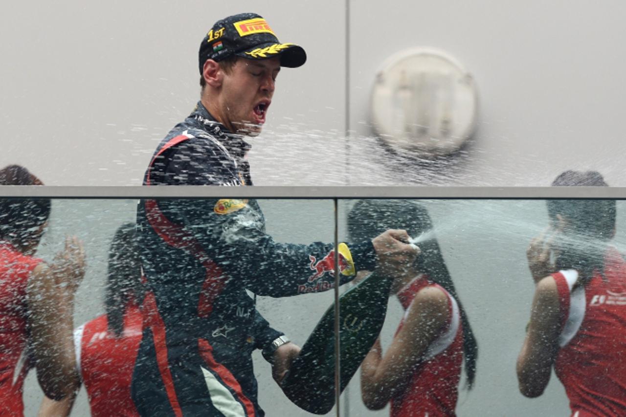 'Red Bull-Renault driver Sebastian Vettel of Germany sprays champagne after winning the Formula One Indian Grand Prix 2012 at the Buddh International circuit in Greater Noida, on the outskirts of New 