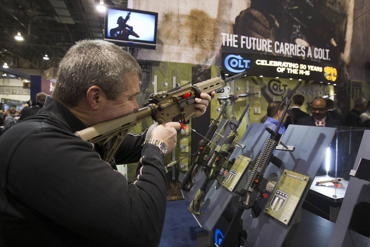 Mark Heitz, of Tactical Firearms in Kingston, New Hampshire, looks over a civilian version of the Colt M4 carbine during the annual SHOT (Shooting, Hunting, Outdoor Trade) Show in Las Vegas, in this file photo taken January 15, 2013. Famed U.S. gun maker 