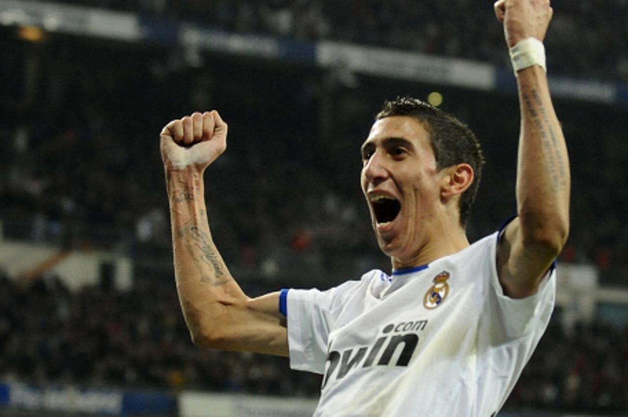 'Real Madrid\'s Argentinian midfielder Angel di Maria celebrates after scoring during the Spanish league football match Real Madrid CF vs Sevilla FC on December 19, 2010 at the Santiago Bernabeu stadi