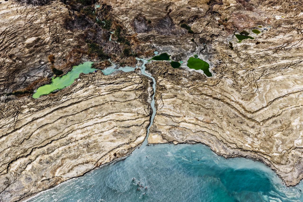 A drone picture shows sinkholes at a shore of the Dead Sea near Ein Gedi, Israel