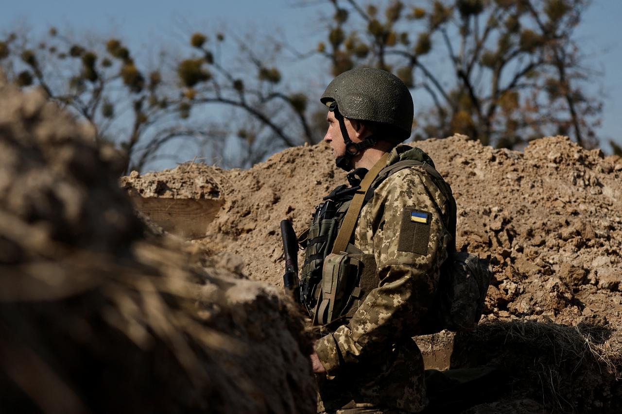 A Ukrainian soldier takes position at an advanced post as Russia's attack on Ukraine continues, in north of Kyiv