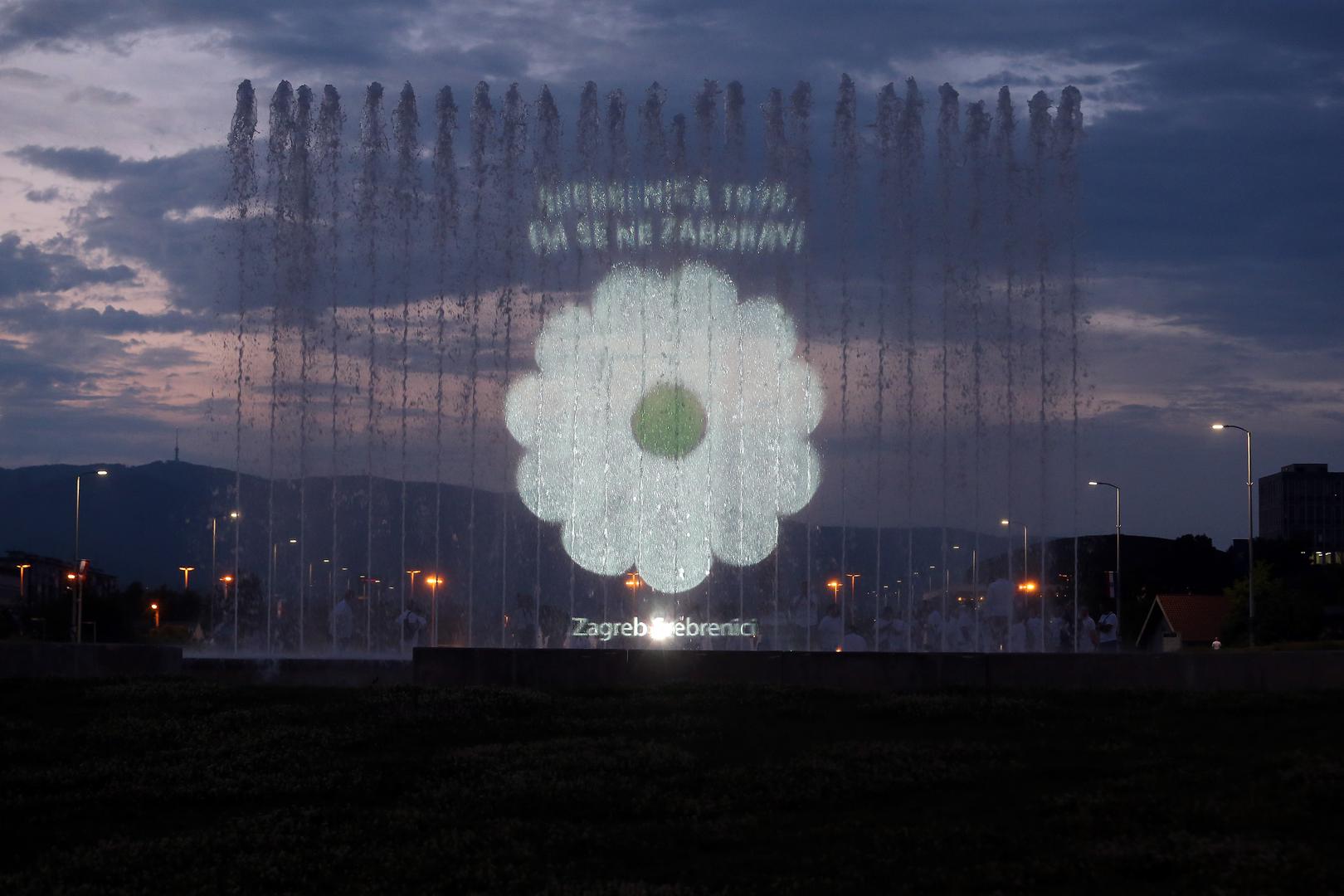 Svjetlosna projekcija cvijeta Sjećanje na fontanama u Ulici Hrvatske bratske zajednice povodom obilježavanja 23. godišnjice genocida u Srebrenici. 