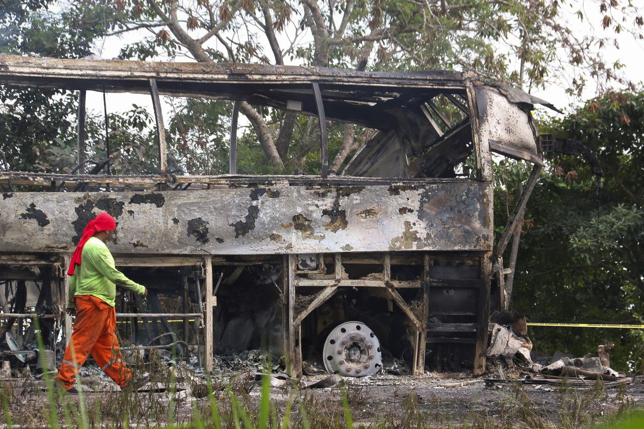 A burned bus is pictured after colliding with a trailer near Escarcega