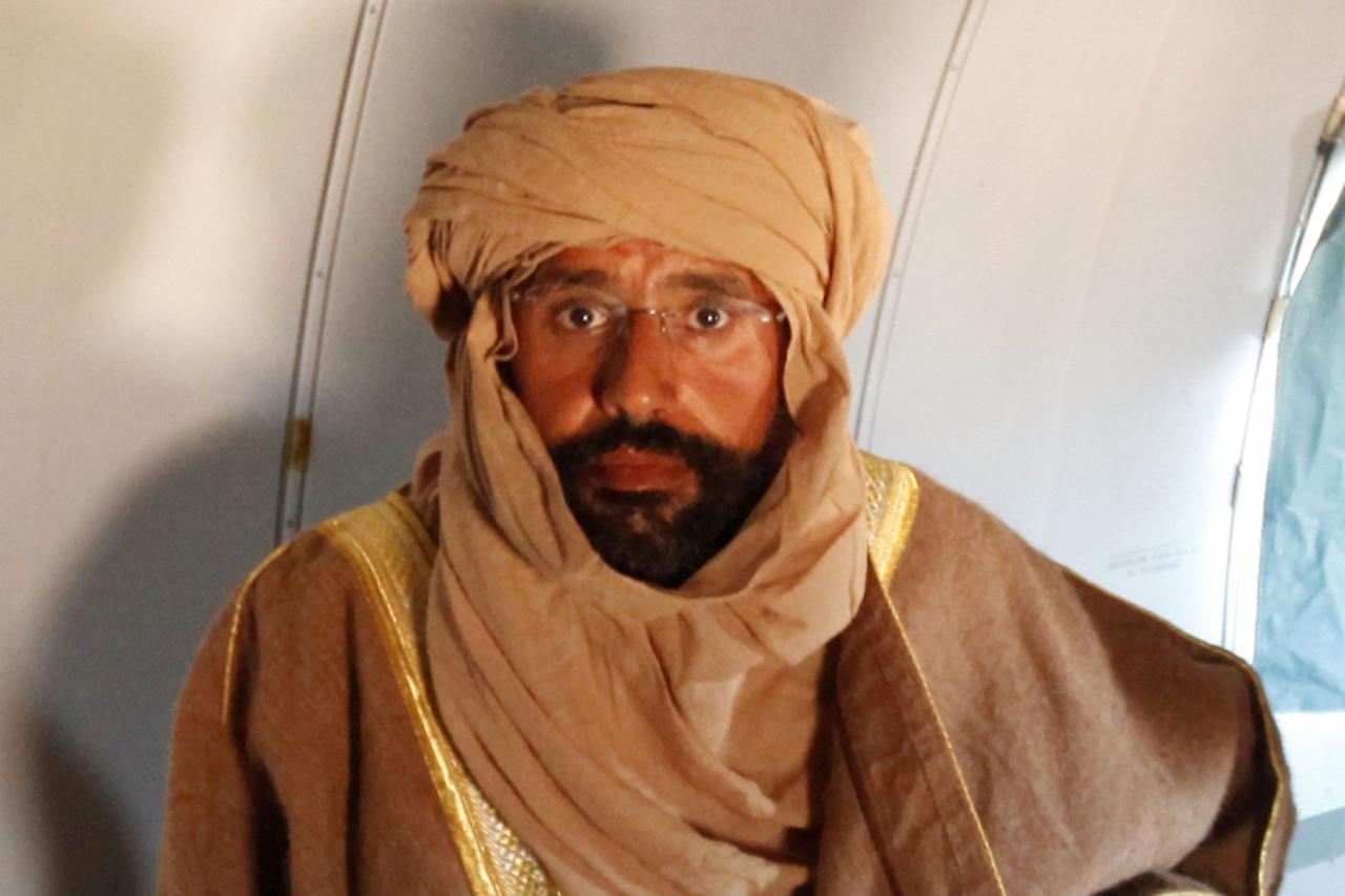 'Saif al-Islam Gaddafi is seen sitting in a plane in Zintan in this November 19, 2011 file photo. The International Criminal Court judges have not taken a decision on whether Saif al-Islam Gaddafi wil