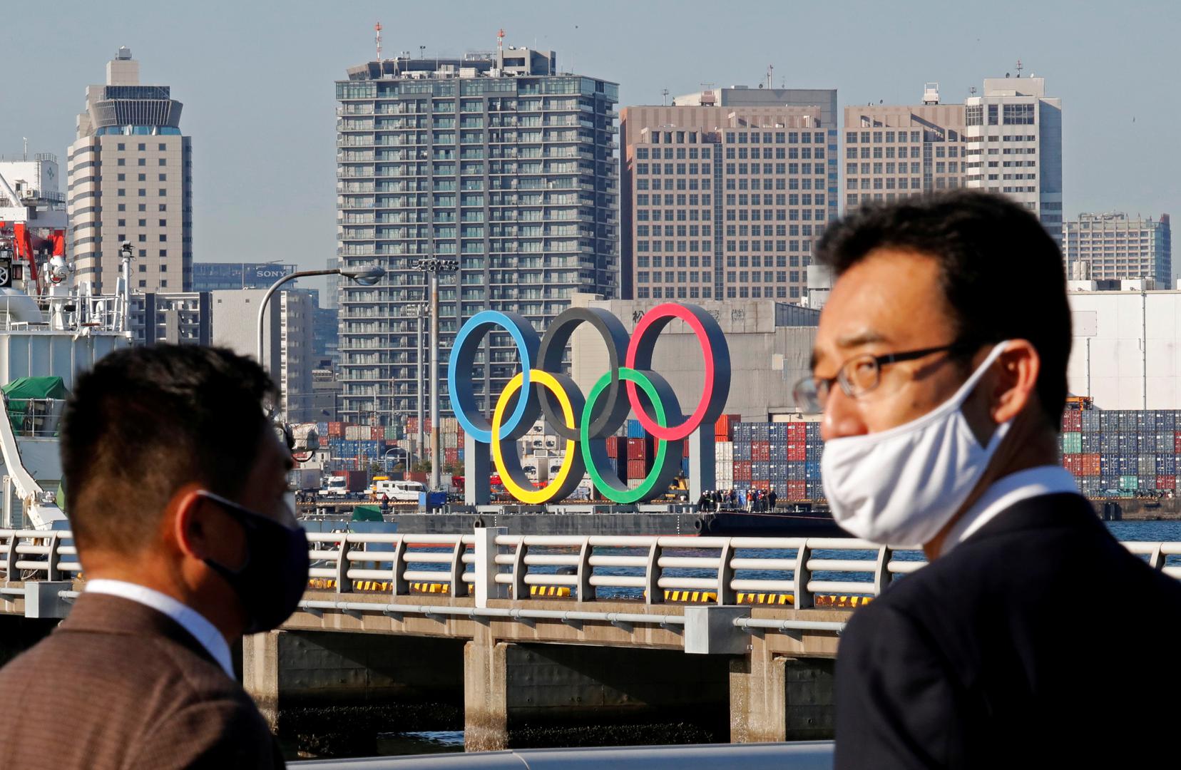 

Ljudi u Tokiju nose maske i gledaju olimpijske krugove koji su premješteni na drugu lokaciju nakon što su Olimpijske igre otkazane zbog koronavirusa.
