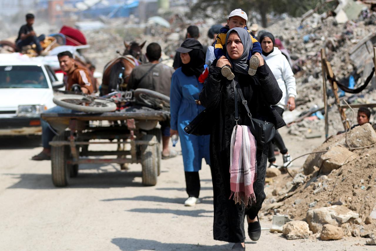 Palestinians make their way to flee their homes, in the northern Gaza Strip