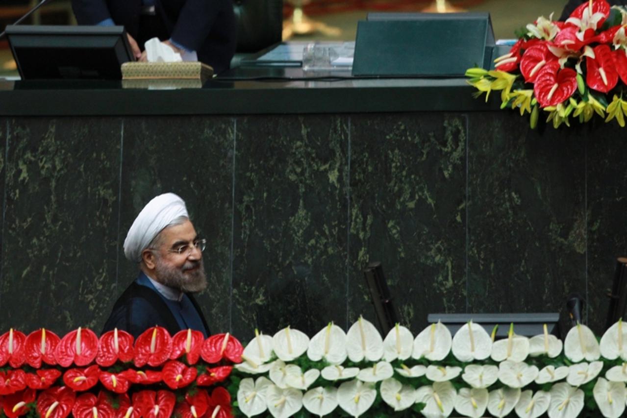 'Iran\'s new President Hassan Rouhani arrives to take his oath of office during a swearing-in ceremony at the Iranian Parliament in Tehran in this August 4, 2013 photo provided by the Iranian state ne