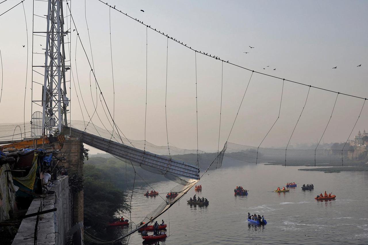 Rescuers search for survivors after a suspension bridge collapsed in Morbi town