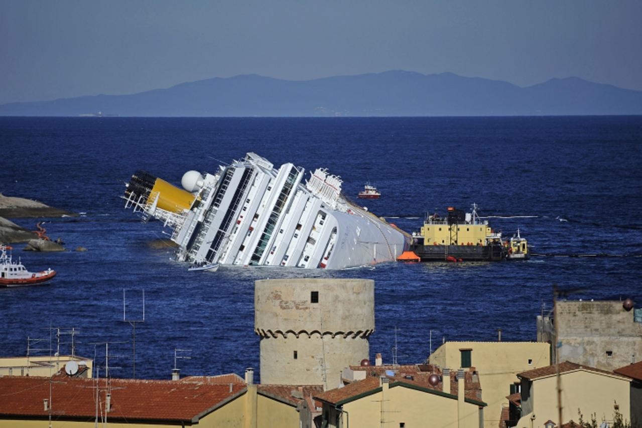 '(FILES) This file picture taken on January 25, 2012 shows the stricken cruise liner Costa Concordia off the Isola del Giglio. Environmental campaign group Greenpeace on March 9, 2012 warned that chem