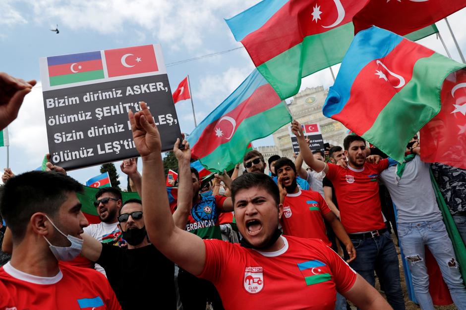 Azeri men living in Turkey shout slogans during a protest in Istanbul