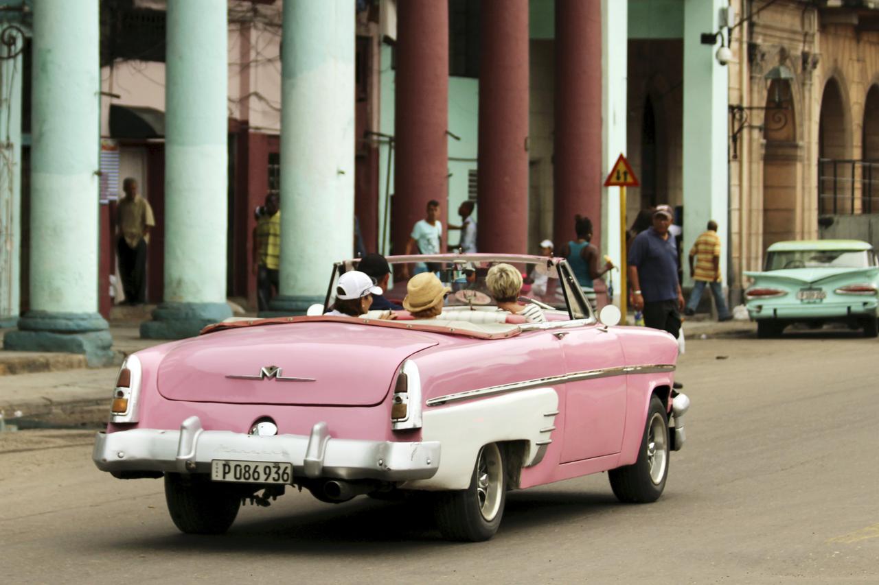 Tourists are chauffeured in a vintage American car through Central Park neighborhood in Havana, Cuba January 17, 2016.   REUTERS/Chris Arsenault