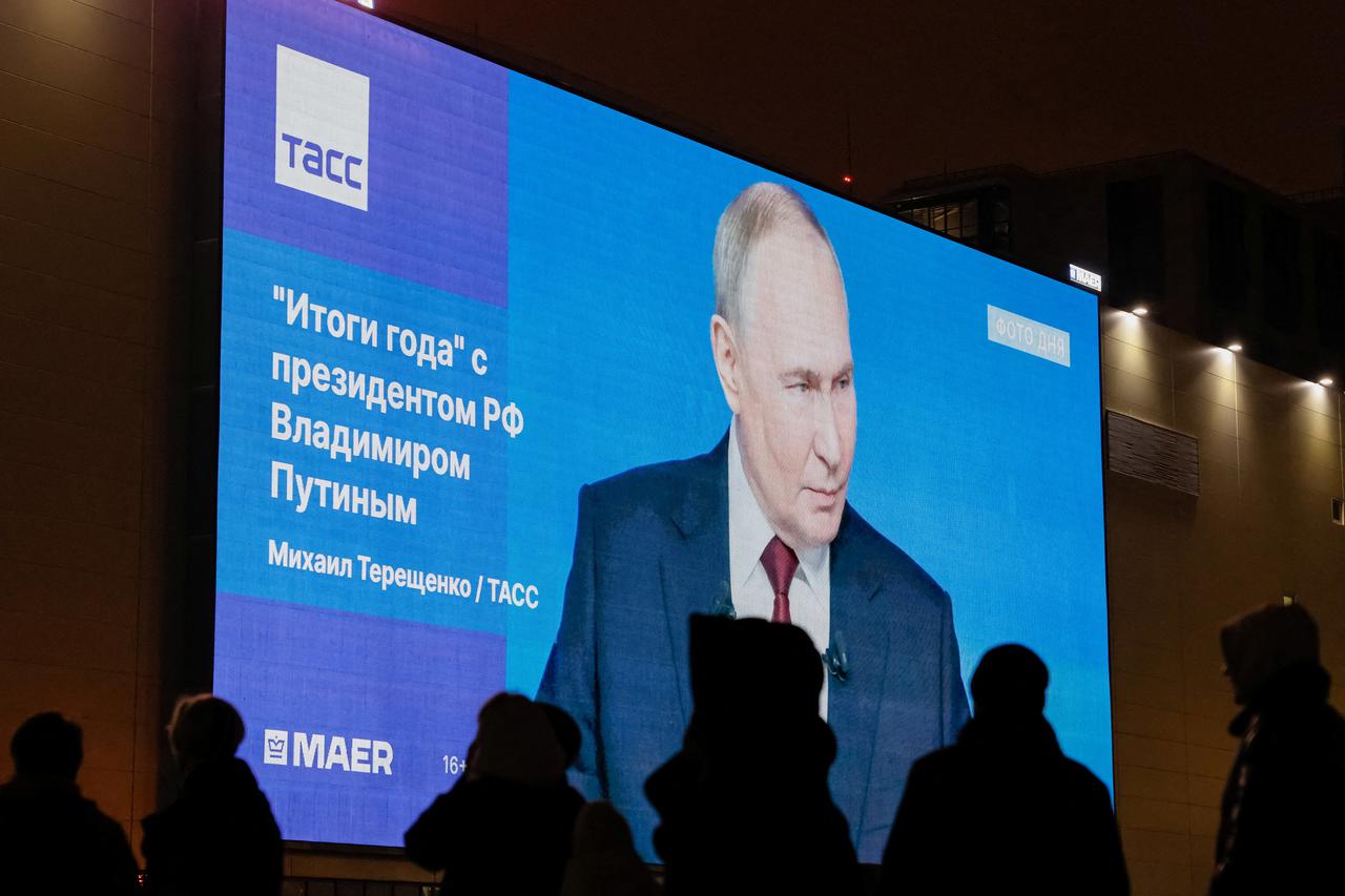 A screen shows a quote from Russian President Putin's annual press conference in Moscow