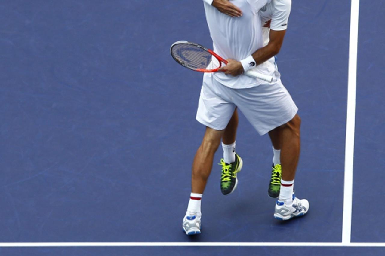 'Ivan Dodig (facing camera) of Croatia and Marcelo Melo of Brazil celebrate after winning the men\'s doubles final against Fernando Verdasco and David Marrero of Spain at the Shanghai Masters tennis t