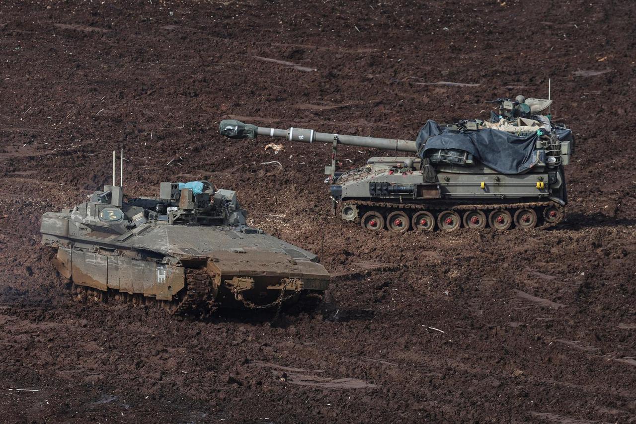 Armoured personnel carriers (APCs) and military vehicles at the Israeli side of the border with Lebanon, in northern Israel