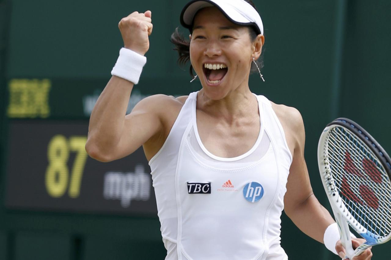 'Kimiko Date-Krumm of Japan celebrates after defeating Alexandra Cadantu of Romania in their women\'s singles tennis match at the Wimbledon Tennis Championships, in London June 27, 2013.    REUTERS/Ed