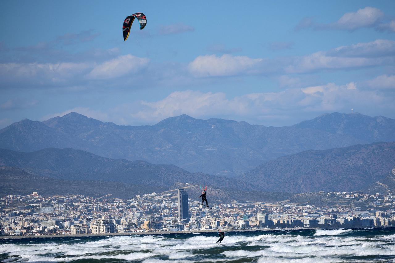 People kite-surf at Lady's Mile beach in Limassol,
