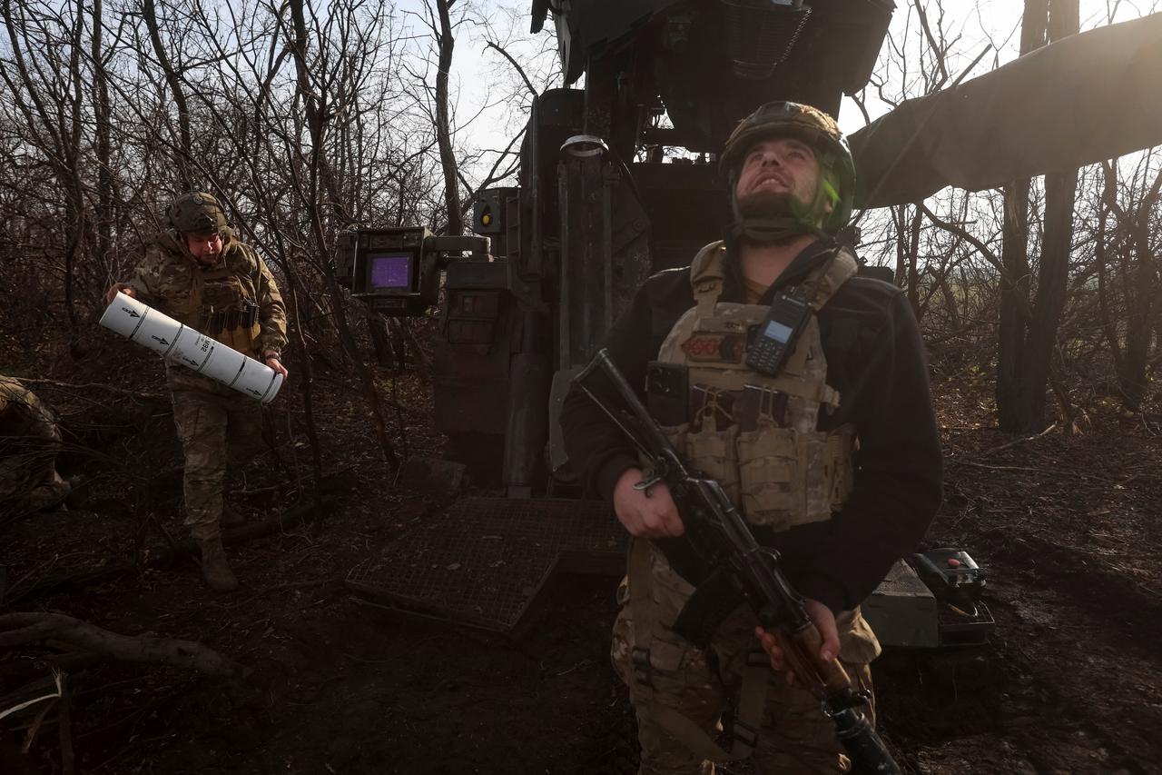 Ukrainian servicemen prepare to fire a self-propelled howitzer towards Russian troopsn near the front line town of Pokrovsk