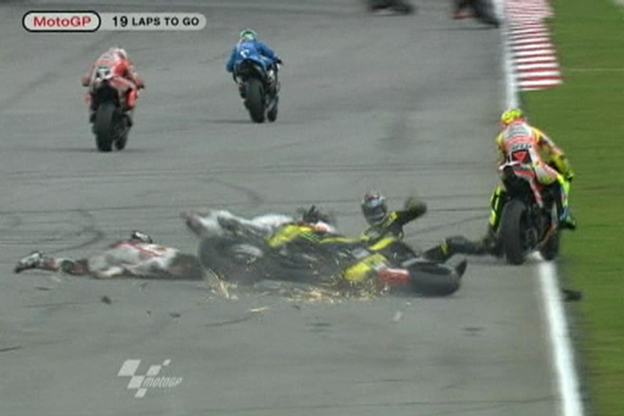 'Honda MotoGP rider Marco Simoncelli of Italy is seen on the ground during a crash involving Yamaha\'s Colin Edwards of the U.S (in black) and Ducati\'s Valentino Rossi of Italy (R) at the Malaysian M