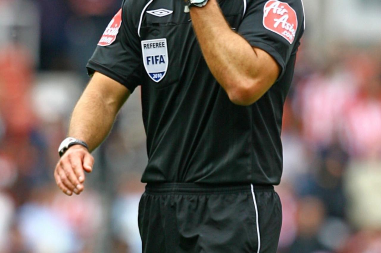 'Referee Howard Webb walks off the pitch at the final whistle Photo: Press Association/Pixsell'