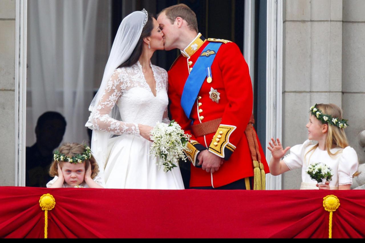 'Prince William and his wife Kate Middleton, who has been given the title of The Duchess of Cambridge, kiss on the balcony of Buckingham Palace, London, following their wedding at Westminster Abbey. P